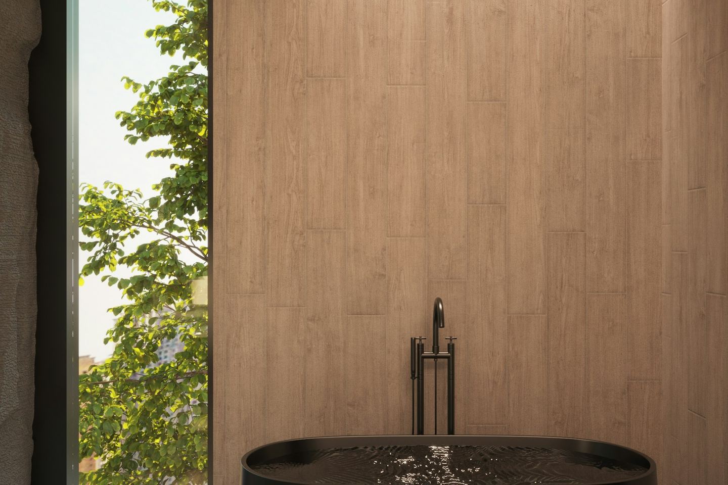 A dark bath beside a window in a quiet bathroom.