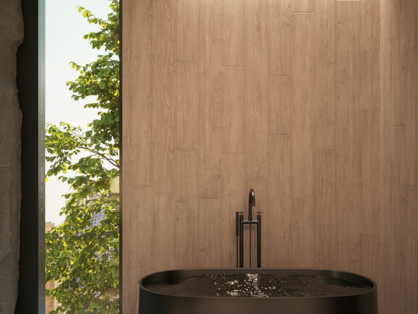 A dark bath beside a window in a quiet bathroom.
