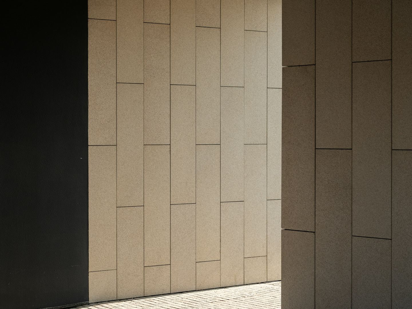 Geometric modern architecture with contrasting light and shadow.