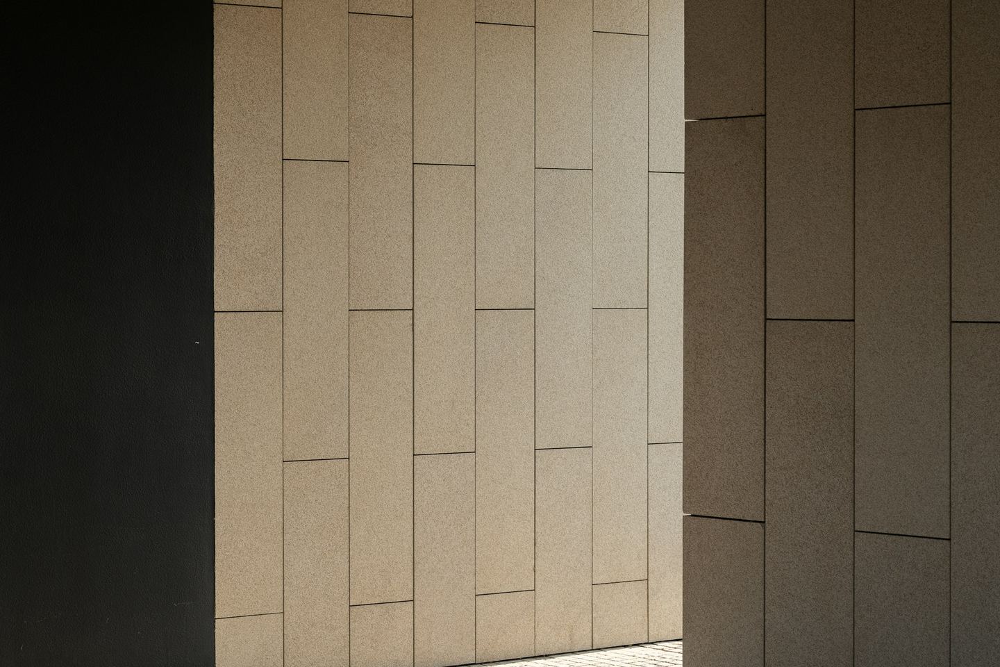 Geometric modern architecture with contrasting light and shadow.