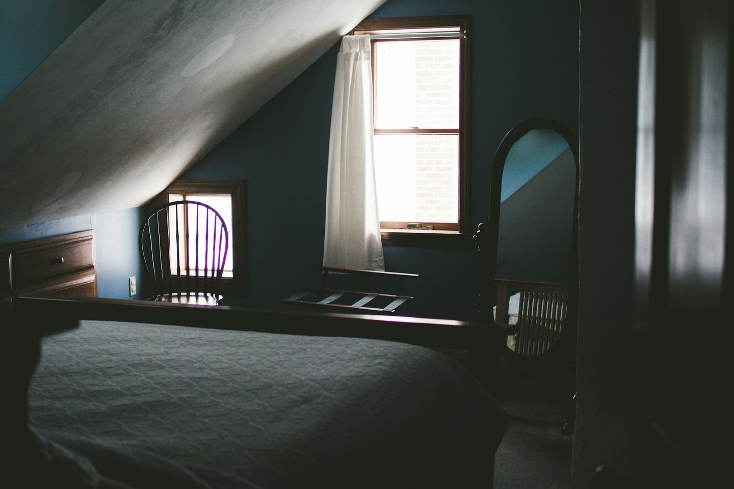 An oval mirror near a window.