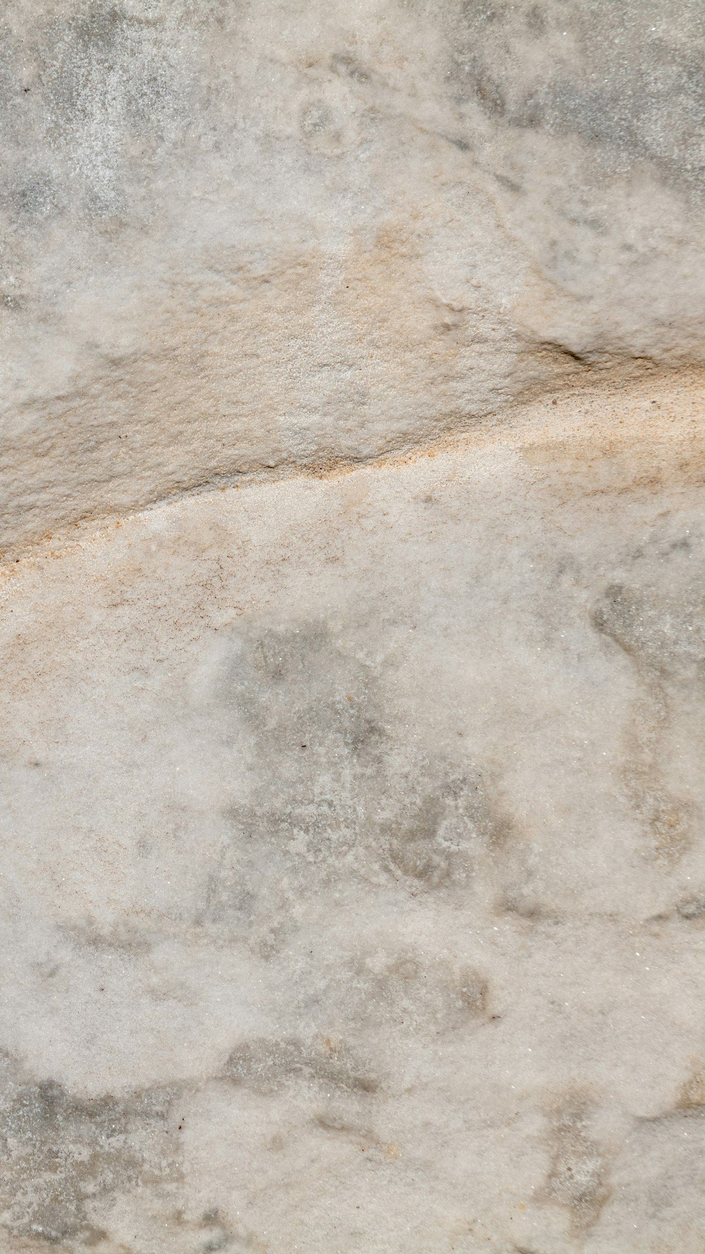Light grey stone with a horizontal ridge.