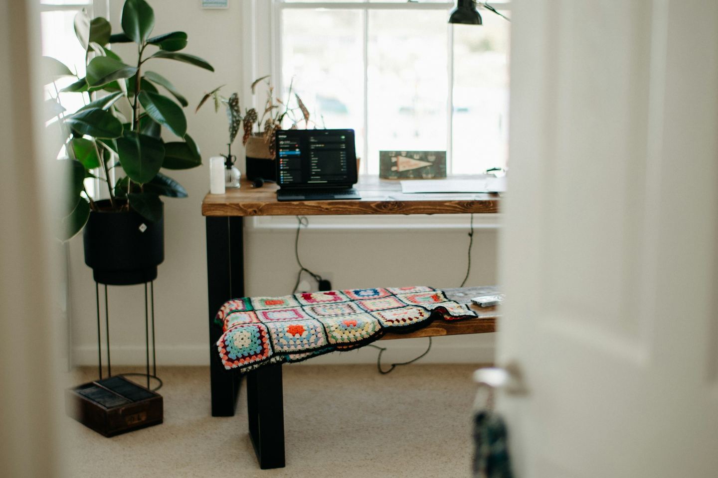 A room with a long table and a bench.