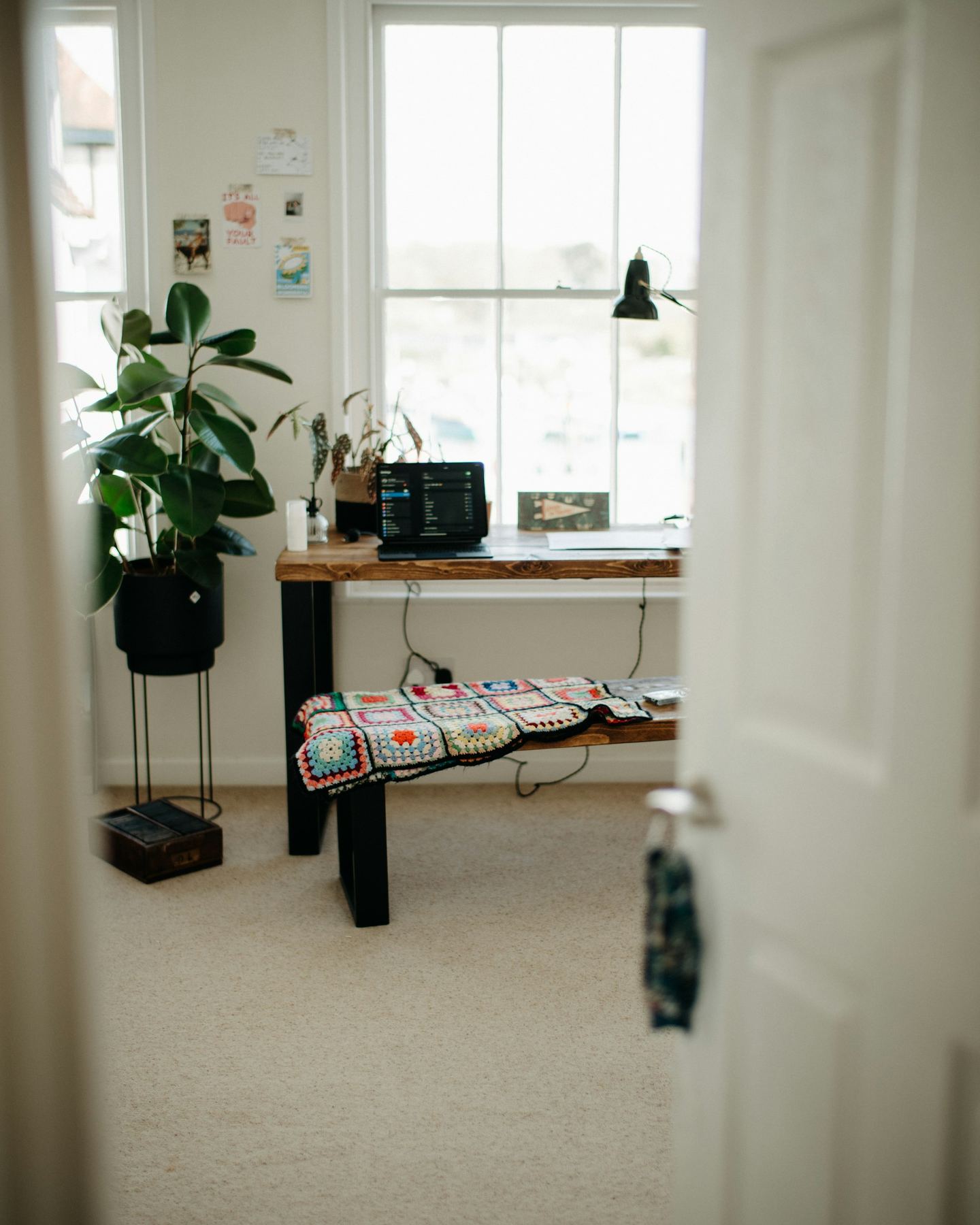 A room with a long table and a bench.