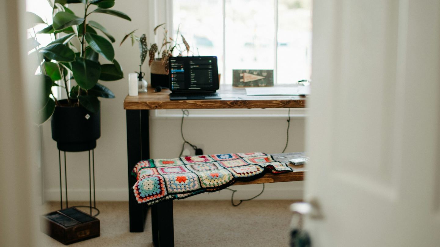 A room with a long table and a bench.