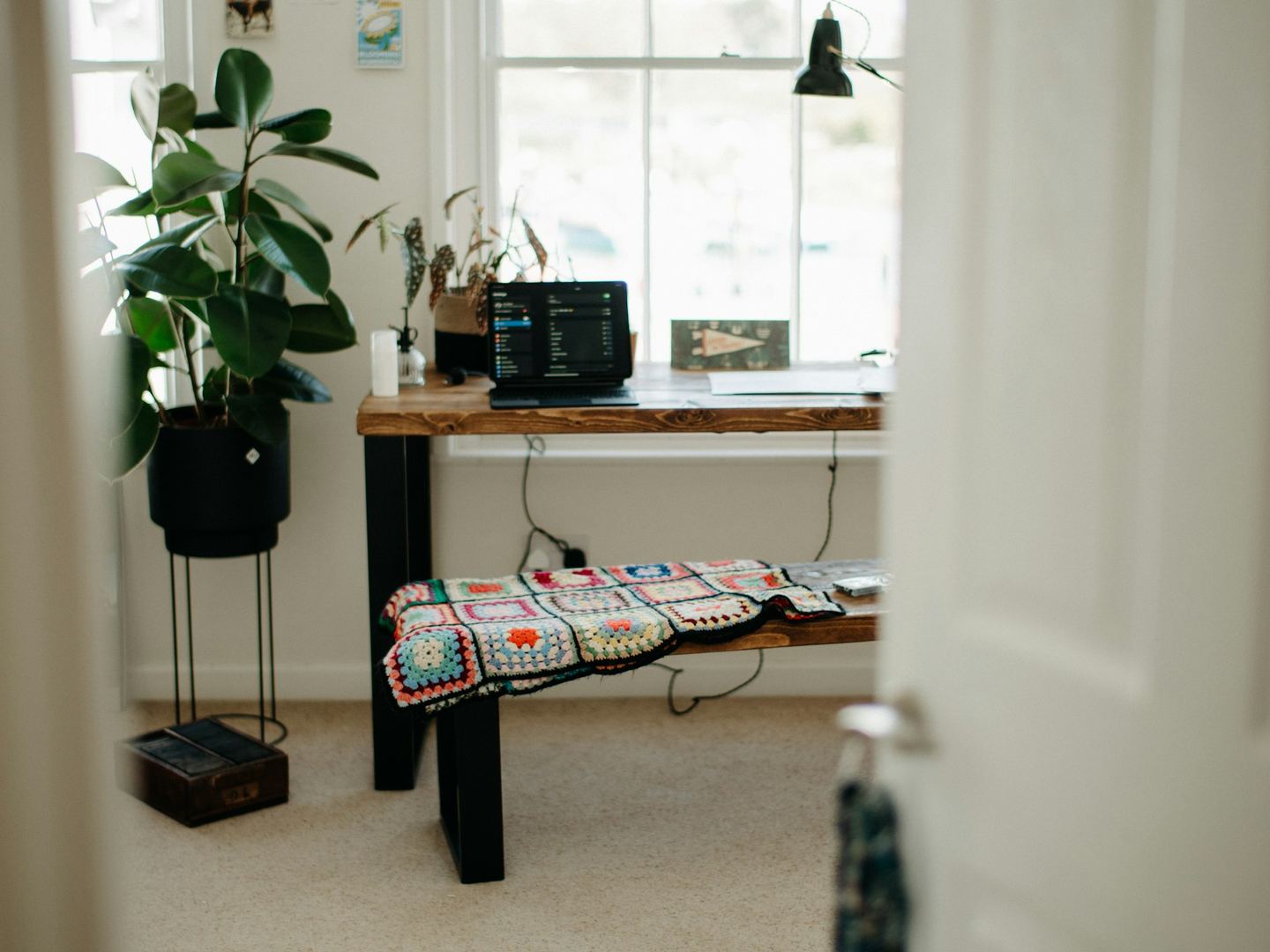 A room with a long table and a bench.