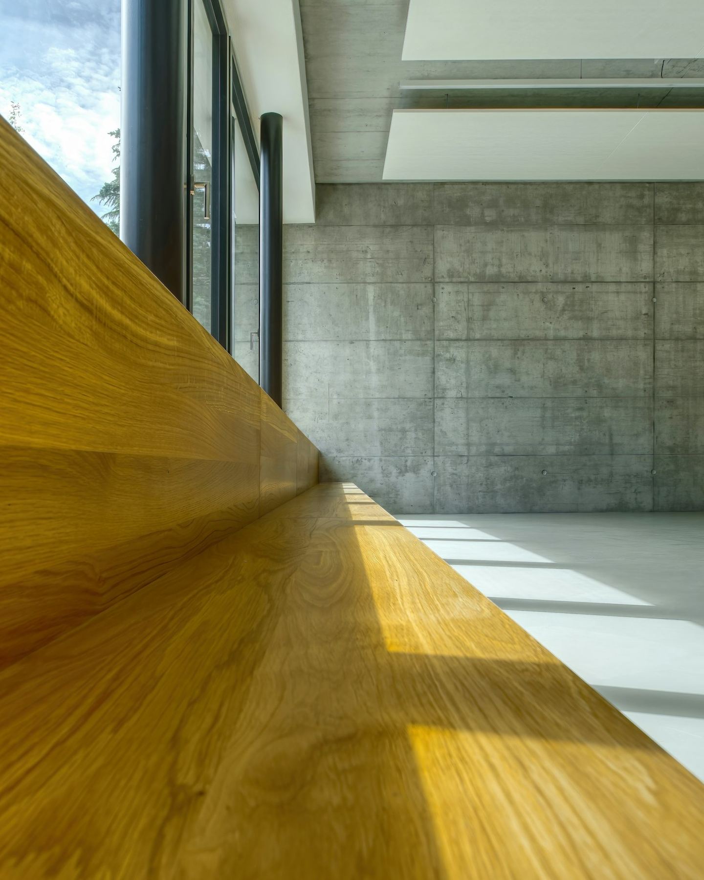 A wooden table against a white wall.