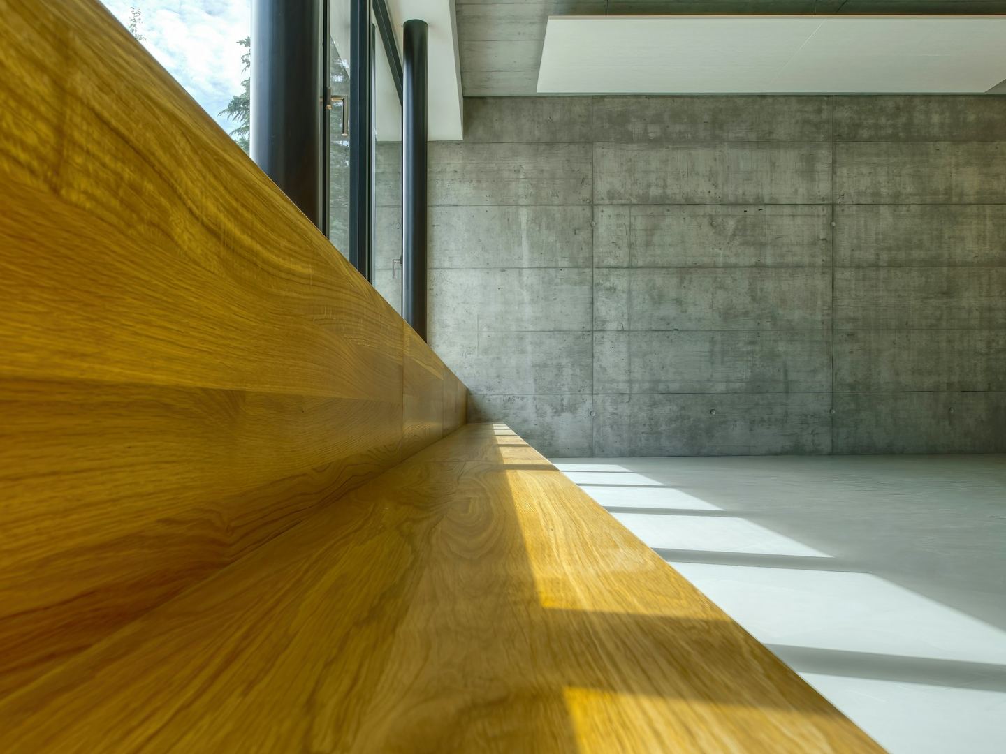 A wooden table against a white wall.