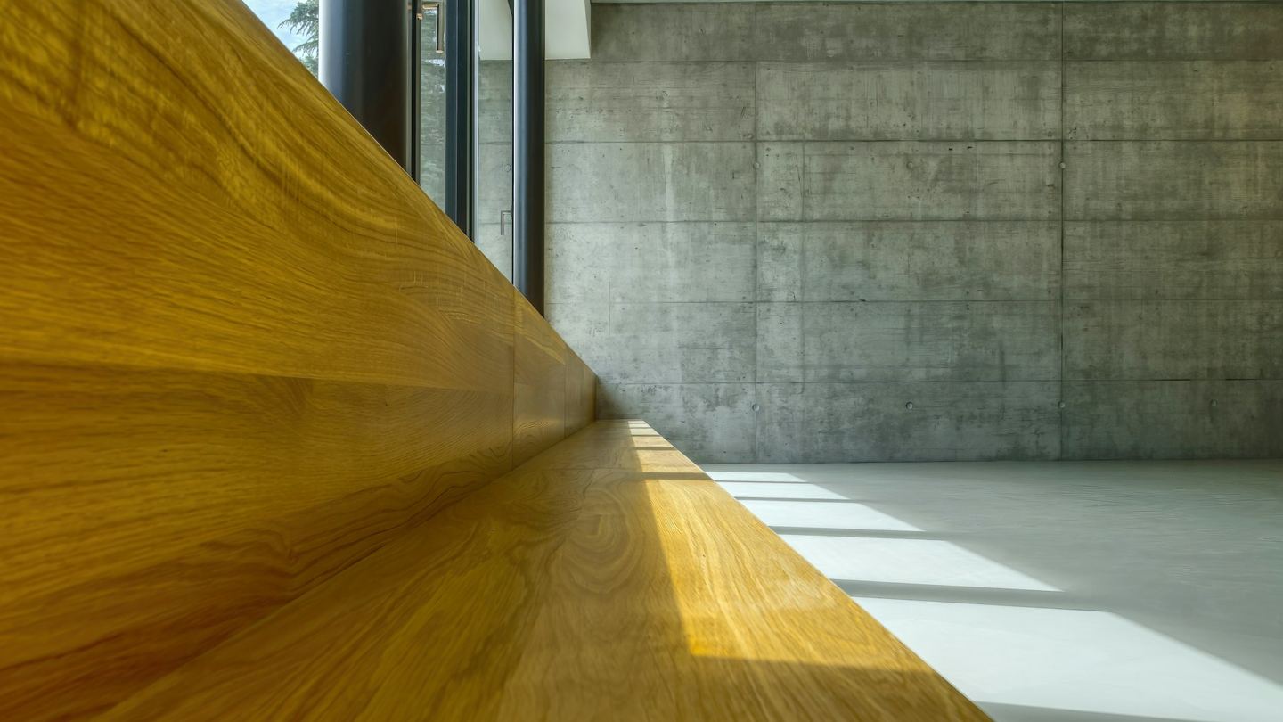 A wooden table against a white wall.
