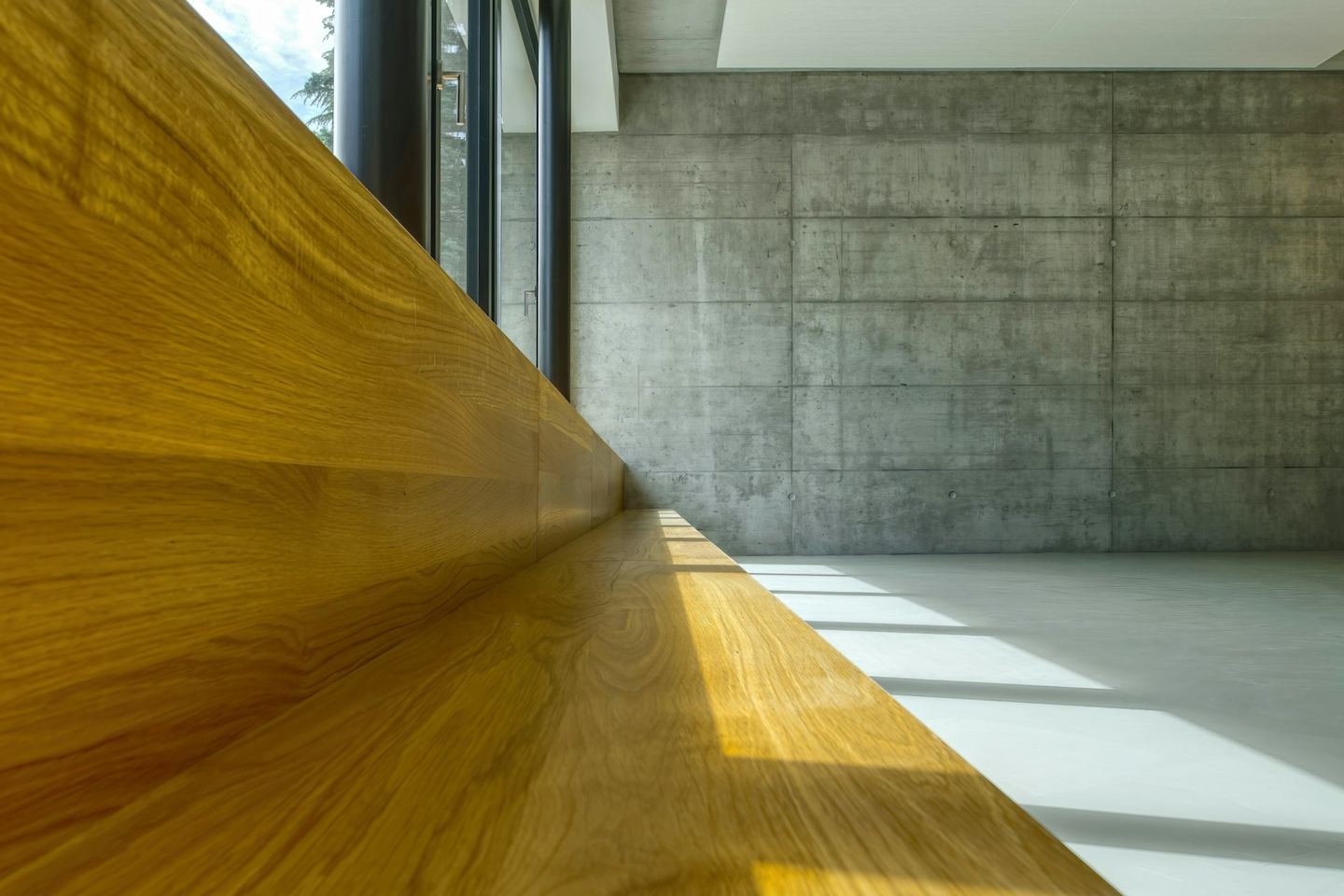 A wooden table against a white wall.