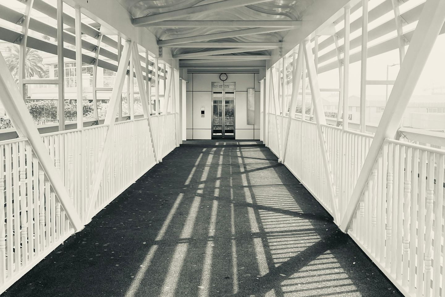 A covered walkway with strong geometric shadows.