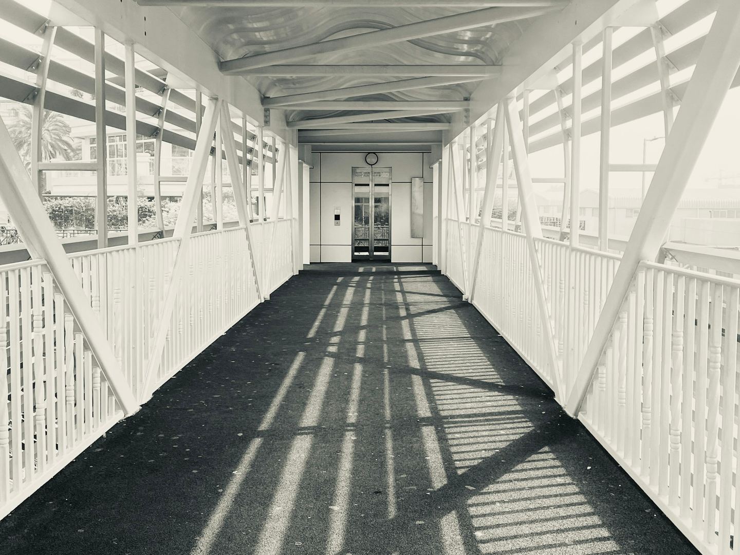A covered walkway with strong geometric shadows.