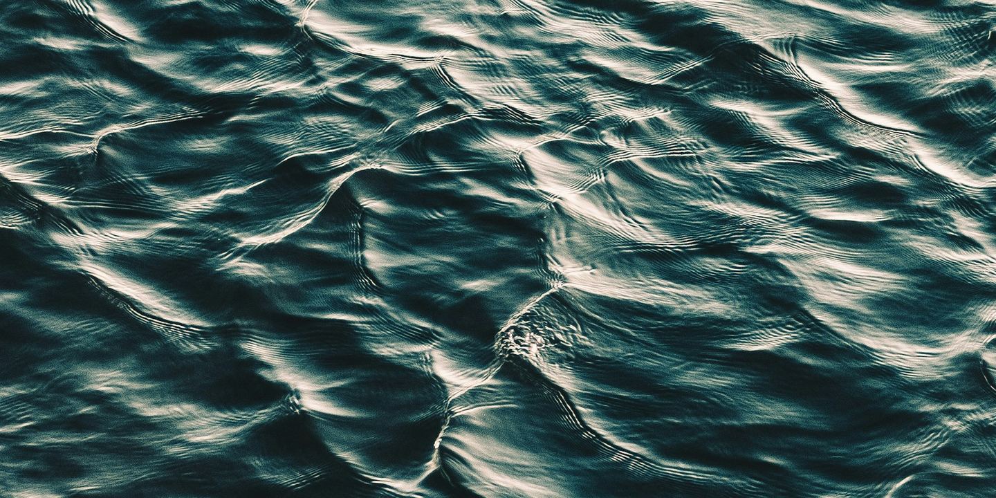 A rippling dark surface of water.